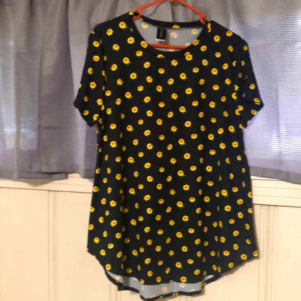 Black blouse embellished with sunflowers.